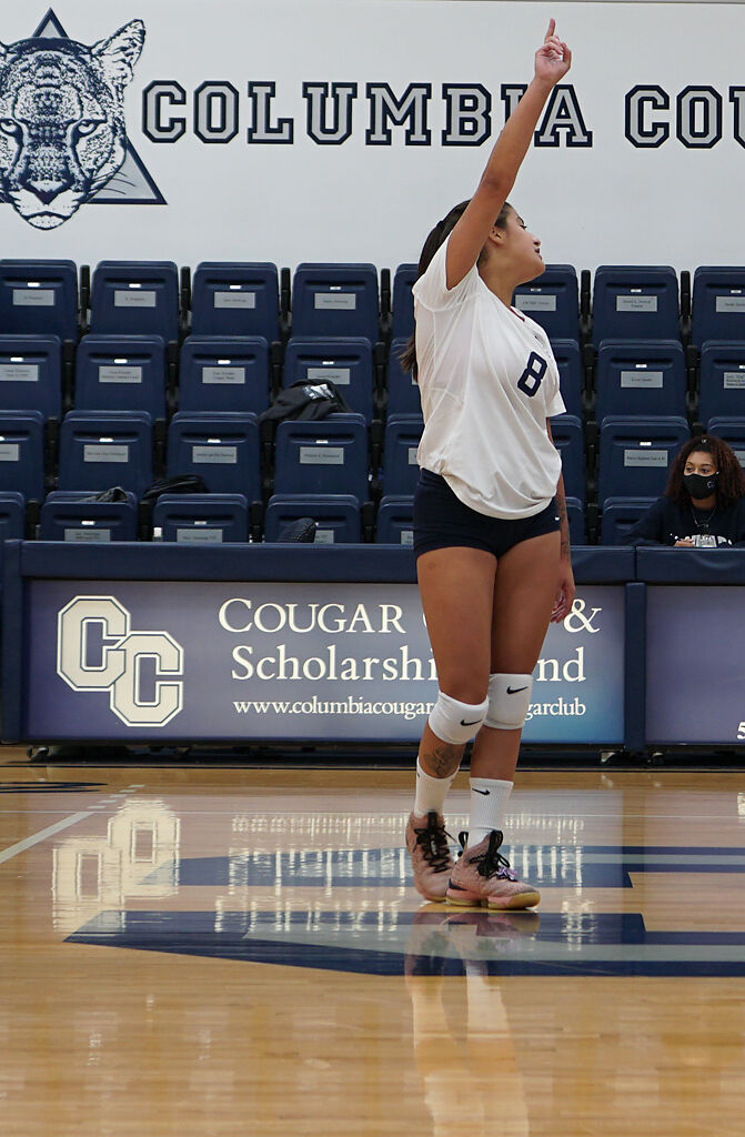 Columbia College setter Luisa Ferreira holds up fingers to indicate the hitters are available for the play on Monday at Southwell Complex.